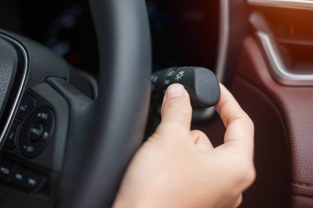istock hand turn on light switch inside car. Safety transportation concept 1400187759
