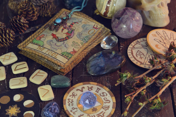Wicca, esoteric and occult still life with vintage magic objects and old tarot cards on witch table altar for mystic rituals and fortune telling. Halloween and gothic concept stock photo