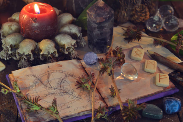 Wicca, esoteric and occult still life with vintage magic objects and open book on witch table altar for mystic rituals and fortune telling. Halloween and gothic concept stock photo