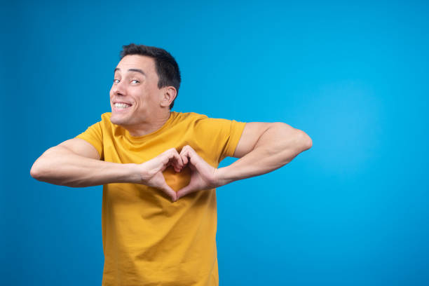 istock Happy man showing heart gesture in studio 1400188817