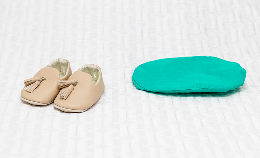 Baby slippers on a bed