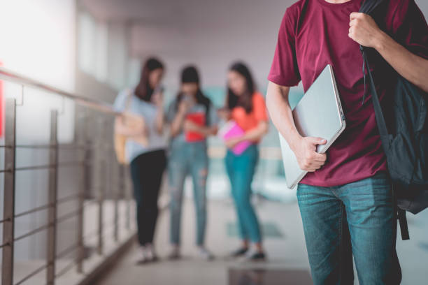 istock A man asian students standing with holding laptop in university, happy education communication communicate. 1400192356