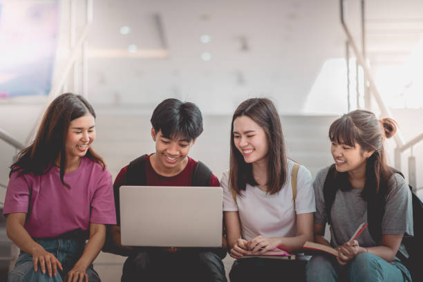 istock Asian group of student using laptop, digital tablet together. Lifestyle with information technology gadget education or social network concept. 1400192388