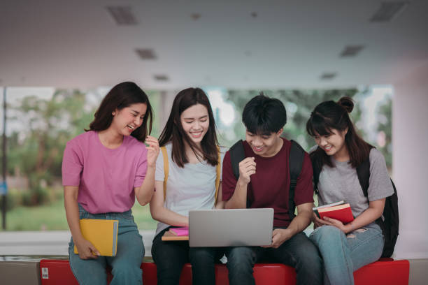 Asian group of student using laptop, digital tablet together. Lifestyle with information technology gadget education or social network concept. Asian group of student using laptop, digital tablet together. Lifestyle with information technology gadget education or social network concept. asian adult student stock pictures, royalty-free photos & images