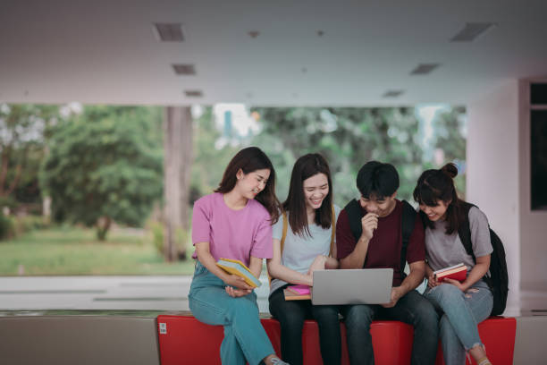 istock Asian group of student using laptop, digital tablet together. Lifestyle with information technology gadget education or social network concept. 1400192439