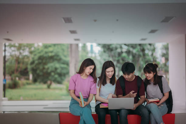 istock Asian group of student using laptop, digital tablet together. Lifestyle with information technology gadget education or social network concept. 1400192473