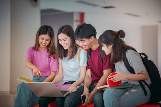 istock Asian group of student using laptop, digital tablet together. Lifestyle with information technology gadget education or social network concept. 1400192475