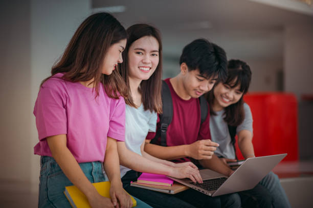 istock Asian group of student using laptop, digital tablet together. Lifestyle with information technology gadget education or social network concept. 1400192476