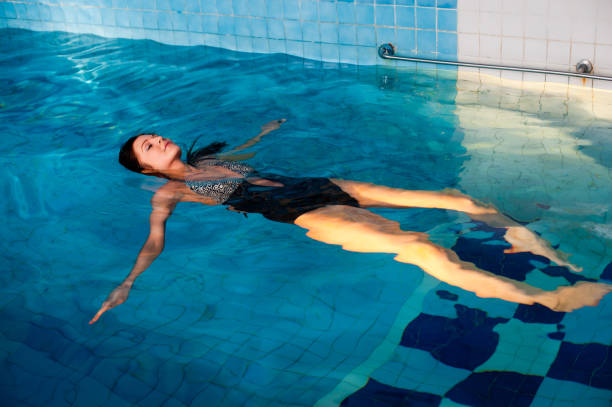 istock Attractive girl relaxes in swimming pool 1400192549