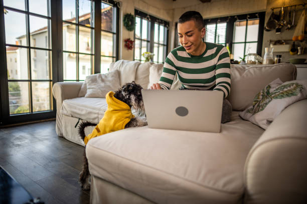 istock Woman with Pet Dog Using Computer at home 1400194838