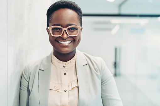 Smiling black businesswoman standing in the office