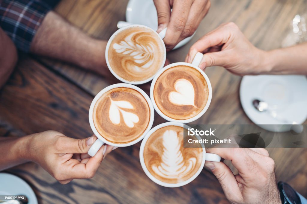 Cappuccino art Above view of hands holding cappuccino cups Coffee - Drink Stock Photo