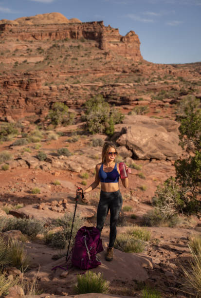 istock Hiker female with backpack in the Utah desert resting and having some water 1400196769