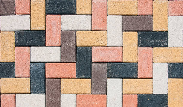 istock The city sidewalk is lined with multi-colored road tiles. View from above. 1400197418