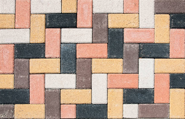 istock The city sidewalk is lined with multi-colored road tiles. View from above. 1400197433