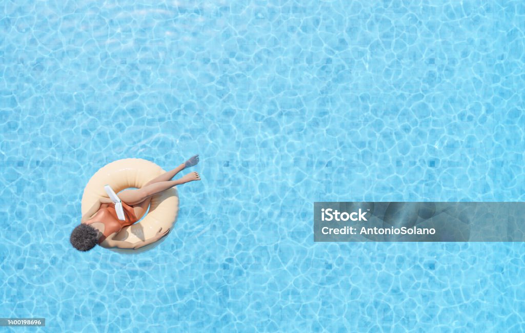Anonymous ethnic lady floating on rubber ring in swimming pool and reading book 3D rendering drone view of anonymous African American female tourist sitting in swim tube in outdoor pool and reading book Relaxation Stock Photo