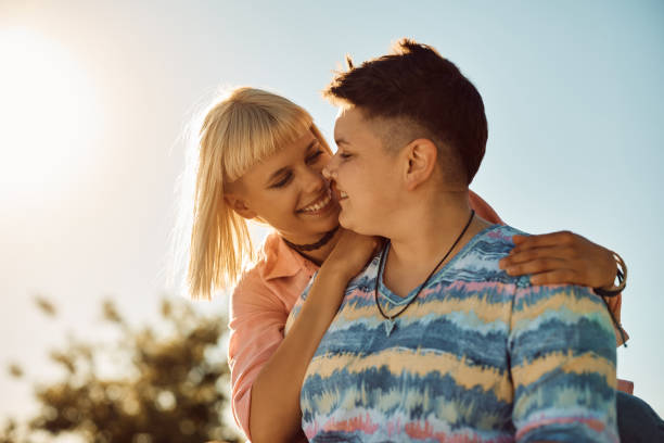 istock Young lesbians in love outdoors against the sky. 1400200549