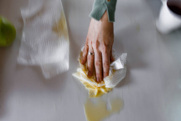 istock Cleaning spilled orange juice in blurred motion! 1400200670