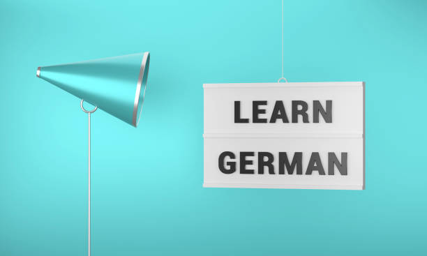 The lightbox with the text Learn German hangs on a rope on a blue background.. Megaphone and announcement concept.