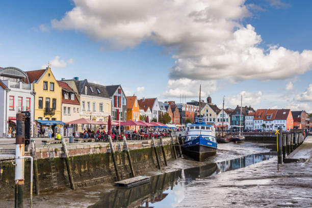 Husum, Schleswig-Holstein, Germany - September 13, 2018. The inland harbor of Husum surrounded by historic houses. Boat moored at the pier.