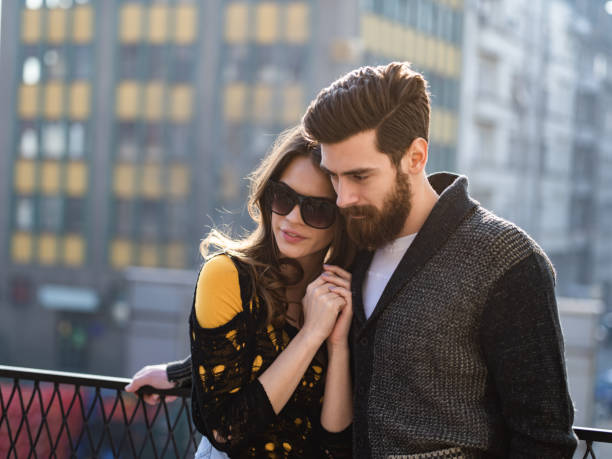 Young couple in love enjoying in their time on a balcony.