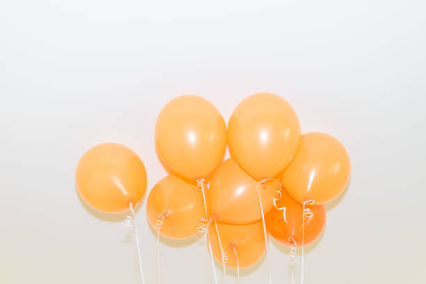 Get into the festive spirit of King's Day in Amsterdam with this vibrant background photo featuring a multitude of orange balloons or balls texture decorating the city streets. Capture the essence of this Dutch national holiday with the colorful and lively atmosphere depicted in this image.