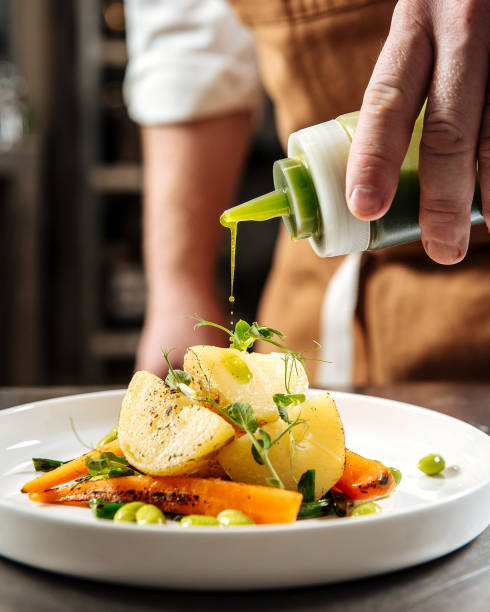 istock Chef pouring gourmet healthy dish with green sauce 1400207264