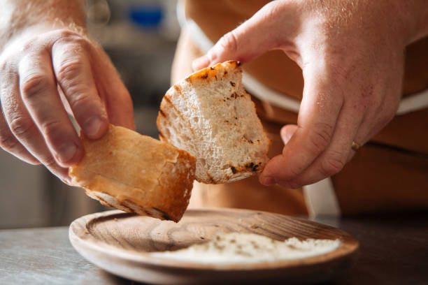 istock Chef rubbing two pieces of toast bread 1400207266