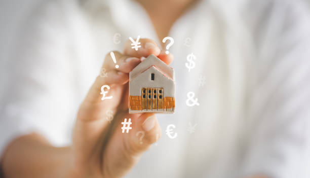 istock woman holding home model on hand 1400207289
