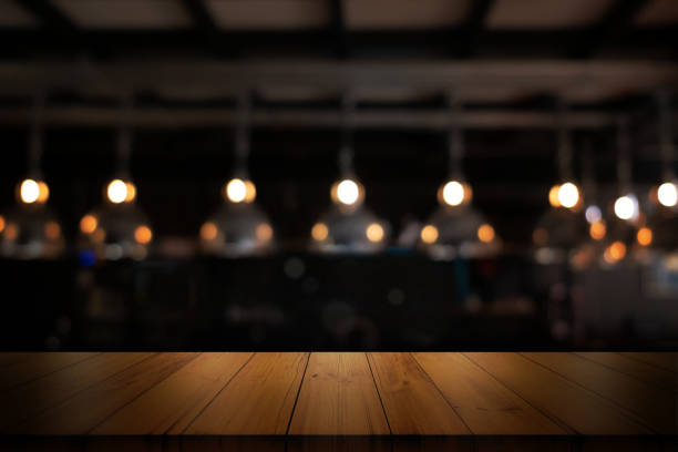 istock Empty wooden table top with blurred coffee shop or restaurant interior background. 1400208758