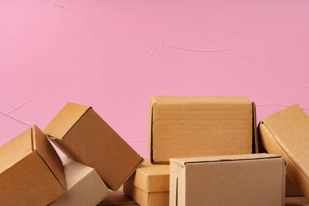 istock Set of cardboard boxes on pink background, close up 1400209751