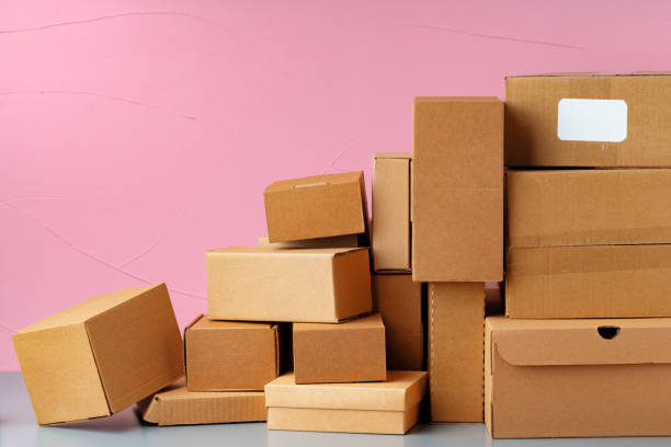 istock Set of cardboard boxes on pink background, close up 1400209753