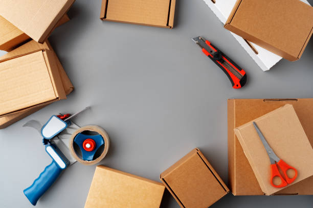 Above table top view of warehouse preparing post courier delivery package box