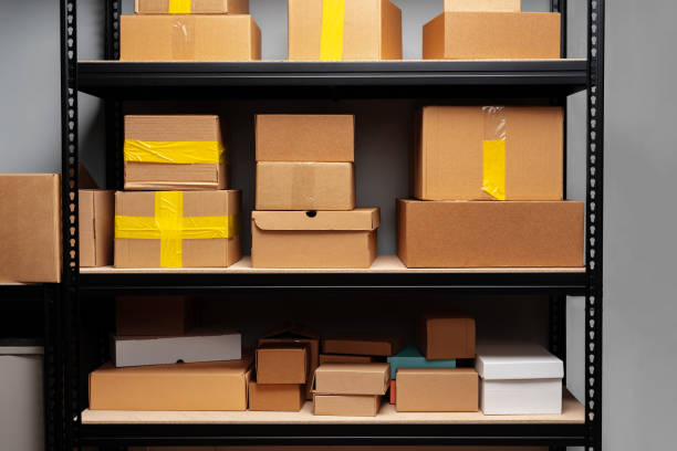 istock Rack shelves with paper boxes in warehouse, close up 1400209814