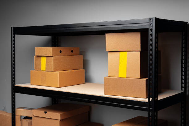 istock Rack shelves with paper boxes in warehouse, close up 1400209819