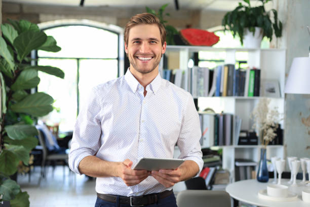 istock Handsome businessman using his tablet in the office. 1400209924