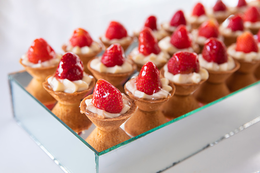 Pastry cupcake dessert with strawberry fruits and cream