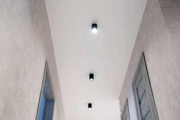 istock Modern lighting in the hallway on a white stretch ceiling. LED spotlights. Beautiful interior. New technology 1400211988