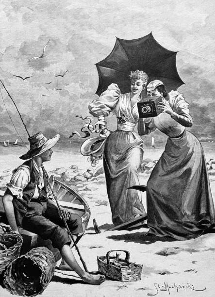 ilustrações de stock, clip art, desenhos animados e ícones de two elegant women on the beach take a photograph of a fisherman boy - camera engraving old retro revival