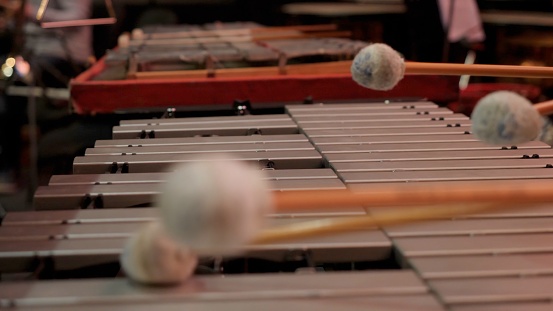 Man playing xylophone with nice drumstick. Human hands playing a glockenspiel close-up