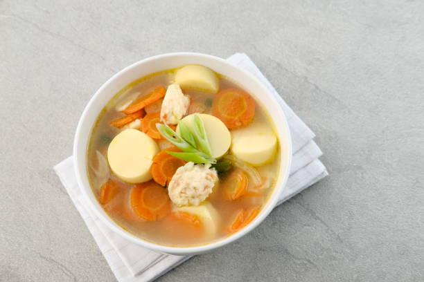 Clear soup with egg tofu, carrot and shrimp meatballs.