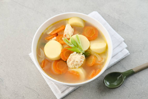 Clear soup with egg tofu, carrot and shrimp meatballs.