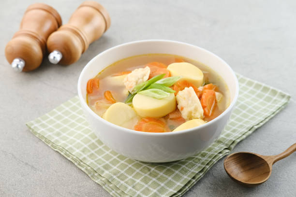 Clear soup with egg tofu, carrot and shrimp meatballs.