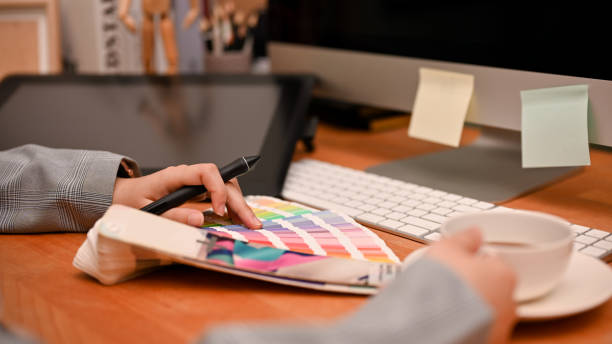 istock Female interior designer examining the colour from colour chart palettes. 1400215687