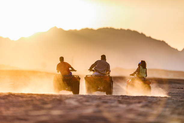istock Driving quad bikes in the desert at sunset! 1400215960