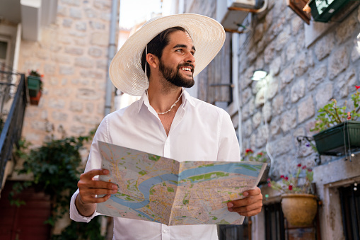 Young tourist with map traveling on summer vacation
