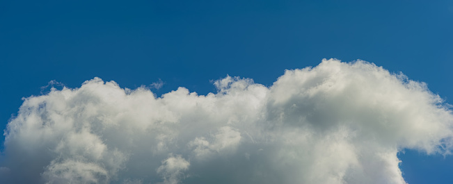 White clouds in the blue sky. Background for design. Web banner.