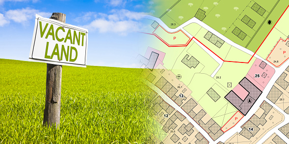 Land plot management - real estate concept with a vacant land on a green field available for building construction in a residential area against and imaginary cadastral map