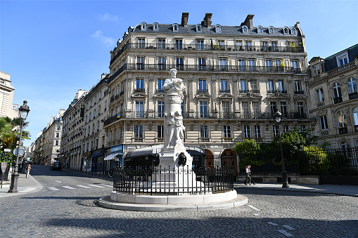 Paris, France-05 28 2022: The Place Saint-Georges is situated at the junction of rue Saint-Georges and rue Notre-Dame-de-Lorette in the 9th arrondissement of Paris, France.A fountain stands at the centre of the square, a bust of the illustrator Paul Gavarni (1804-1866) tops the monument.