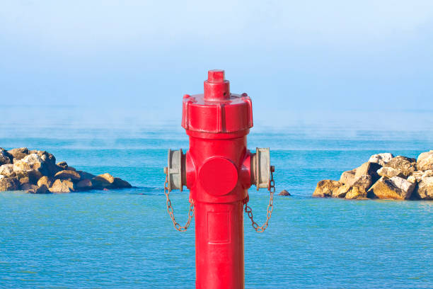 istock An improbable hydrant at the seaside - Plenty of water concept with an hydrant against a seascape 1400222915